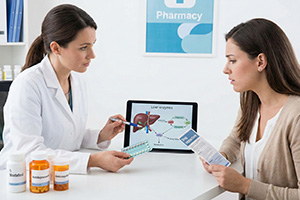 Pharmacist explaining critical drug interactions between modafinil, birth control pills, antidepressants, and anticoagulants using a liver enzyme diagram.